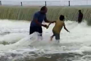 man, boy washed away in water