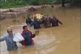 No road to cemetery: villagers carried dead body in water