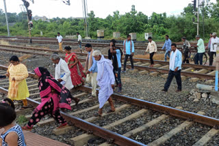 people crossing rail tracks In Dumka