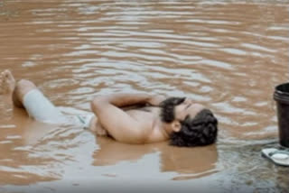 Kerala man bathe in pot hole; unique protest against gutters on road