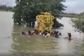 ead body carried through flooded Cauvery river in Mandya