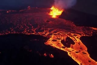 LAVA FLOWS OUT OF A FISSURE IN A VALLEY NEAR MOUNT FAGRADALSFJALL IN ICELAND