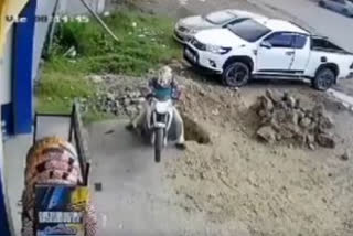 Watch: Pothole swallows man and his bike in parking space