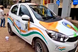 Man sticking photos of freedom fighters on his car