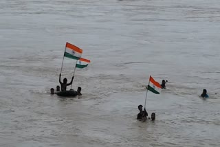 young man is in the limelight for bravely flying a tricolor in the river