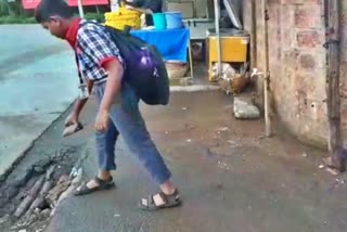 student who covered the road pothole