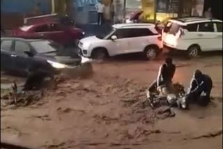 Bike washed away on Rishikesh road due to heavy rainfall