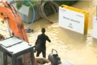 Bengaluru: Man stuck on a waterlogged road rescued by security guards