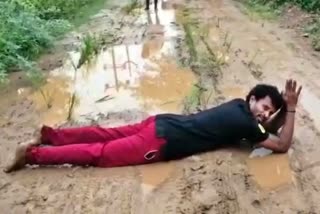 Young man protested by rolling over the road to build the new road