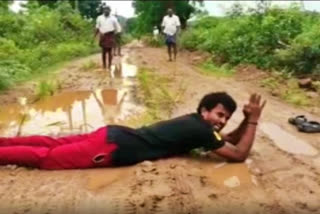 AP: Youth protests against bad road condition by rolling on road