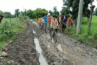 Children go to school through mud