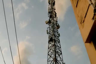 Farmer climbing the cell tower