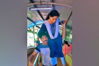 Husband climbs atop of Tirumala shrine by carrying wife on shoulder: video viral