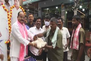 TRS leader Rajanala Srihari distributes liquor bottles and chicken to locals ahead of Telangana CM KC Rao launching a national party tomorrow, in Warangal