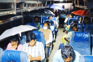 Passengers Traveling In RTC Bus With Umbrellas