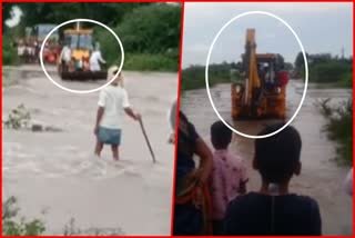 People crossed flooded ditch by sitting on JCB bucket in kappal of Karnataka