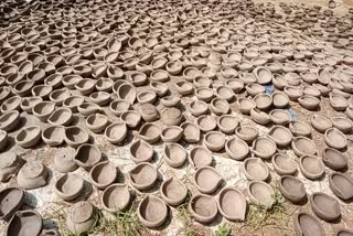 Pottery artists clay candles of various shapes for Diwali in Assam