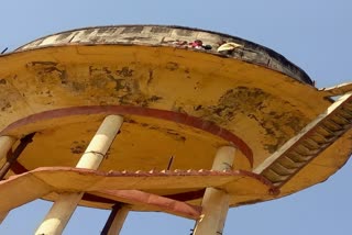 Monk Climbed on Water Tank