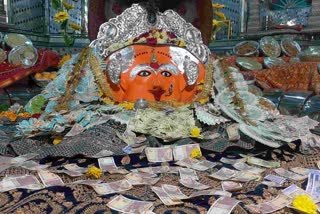 Ten rupee note offered to devotees as prasada