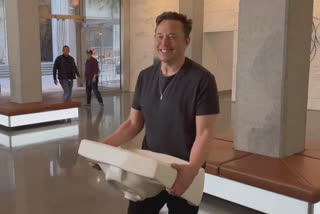 'Let that sink in!' says Musk as he enters Twitter HQ - with an actual sink