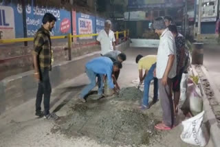 group of youths are quietly patching pathholes