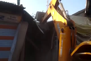 dewas police run bulldozer on rapist illegal shop