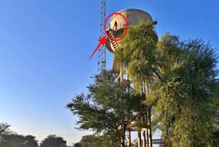 Woman climbed on water tank