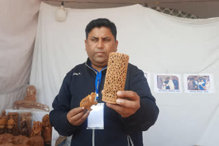 International Gita Festival Tourists crazy about the wood carving of craftsman Neeraj