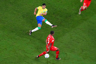 Brazil's Casemiro, top, scores his side's opening goal during the World Cup group G soccer match between Brazil and Switzerland, at the Stadium 974 in Doha, Qatar, Monday, Nov. 28, 2022.