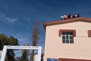 Students climb the roof of the college with petrol