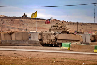 FILE - American soldiers patrol near prison that was attacked on Jan. 20 by the Islamic State militants in Hassakeh, Syria, Feb. 8, 2022. U.S. forces have stopped joint military patrols in northern Syria to counter Islamic State extremists, as Turkish threats of a ground invasion stymie those missions with Kurdish forces. (AP Photo/Baderkhan Ahmad, File)