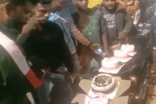 youths cut birthday cake with sword