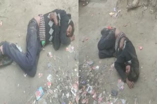 Drunk man sleeping on road in Siwan