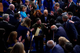 Ukrainian President Volodymyr Zelenskyy holds an American flag that was gifted to him by House Speaker Nancy Pelosi of Calif., as he leaves after addressing a joint meeting of Congress on Capitol Hill in Washington