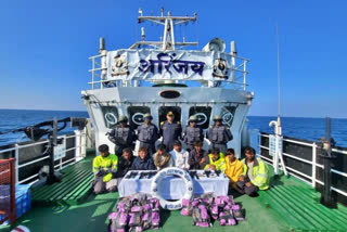 Coast Gurad officials with the seized drugd and arrested crew members of the Pakistani boat