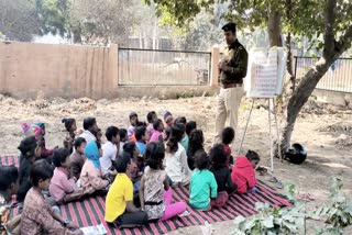 Policeman giving education to destitute children