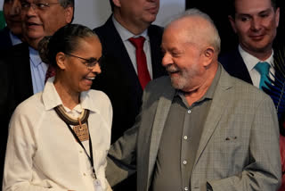 Brazil's President-elect Luiz Inacio Lula da Silva and newly-named Environment Minister Marina Silva, smile during a meeting where he announced the ministers for his incoming government, in Brasilia