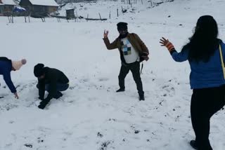 Tourists enjoying snowfall in Kashmir