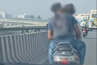 Couple romances while riding scooty in Mysore