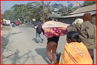 Dead body carried on shoulder