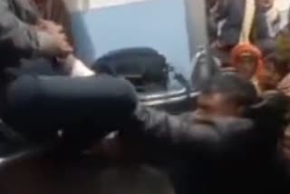 Two railway officials thrashing passenger