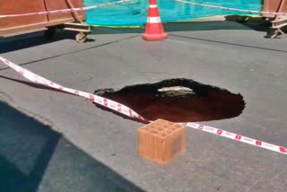 A portion of a road caved in at Ashok Nagar in Bengaluru amid ongoing work related to metro construction underground on Thursday.