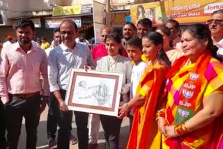 Young Woman presents Portrait to PM Modi