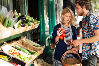 Couple buying vegitavles at store