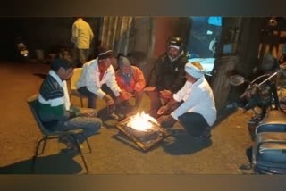 People warming their hands in front of a fire