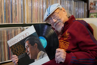 FILE - Ray Cordeiro, Hong Kong's oldest DJ displays records at his home in Hong Kong, Thursday, May 27, 2021. Cordeiro considers himself the luckiest radio DJ in the world. Cordeiro, who interviewed music acts including the Beatles during a six-decade career on Hong Kong radio that earned him the title of the world's longest-working disc jockey, died Friday, Jan. 13, 2023, his former employer announced. He was 98. (AP Photo/Kin Cheung, File)