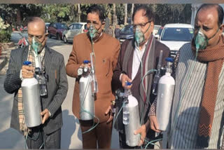 BJP MLAs sport oxygen cylinders, gas masks