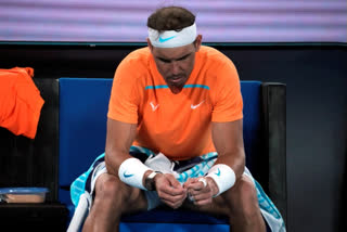 Rafael Nadal of Spain reacts during his second round loss to Mackenzie McDonald of the U.S. at the Australian Open tennis championship in Melbourne, Australia, Wednesday, Jan. 18, 2023. (AP Photo/Dita Alangkara)