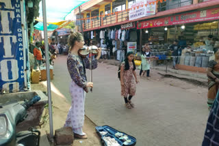 Foreigner woman plays violin on the streets of Gokarna