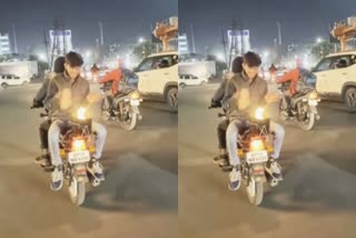 young man is lighting a fire in a moving  bike in madhyapradesh indore